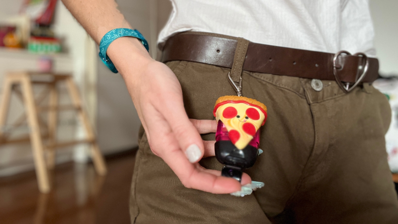 Author holding a pizza hand sanitizer holder.