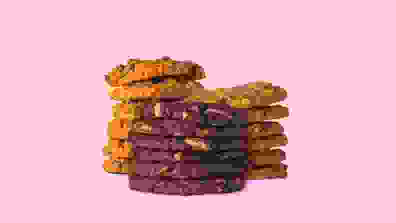 Three stacks of cookies against a light pink background.