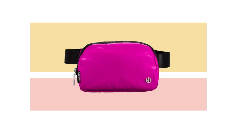A pink lululemon belt bag against a light gold and pink background.