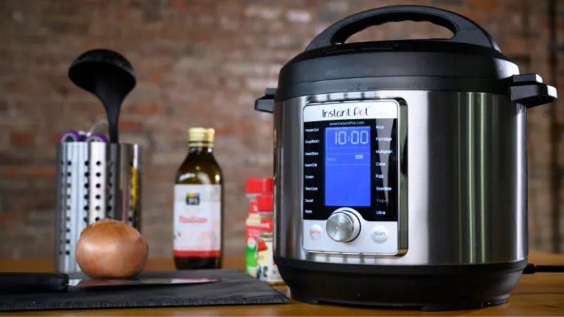 An image of an Instant Pot Ultra on a countertop next to several cooking oils and condiments.