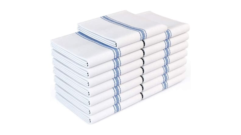 A stack of white kitchen dish towels with dark blue stripes on the outer edges.