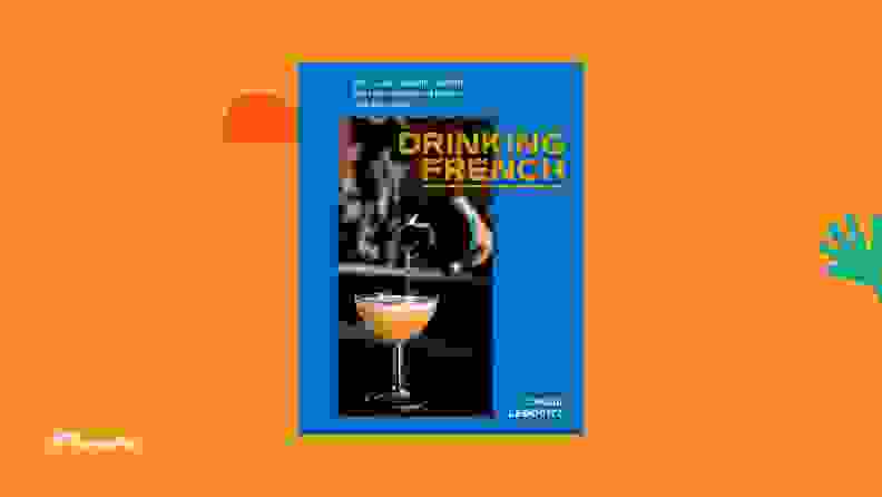 Drinking French cookbook against a bright orange background.