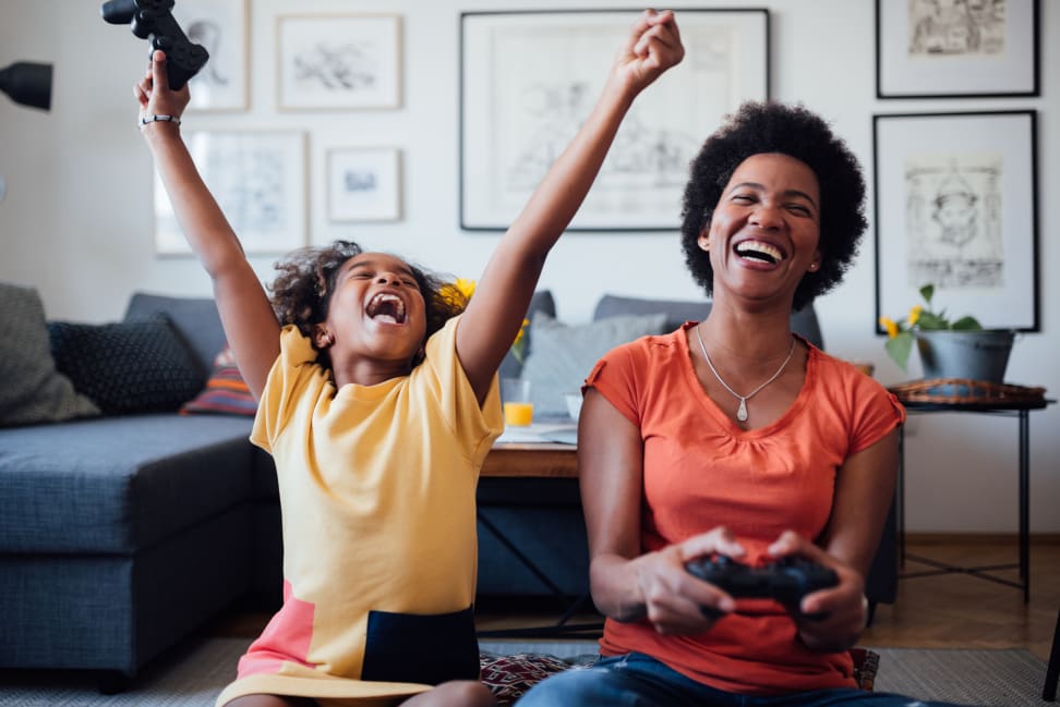 A mother and her daughter playing video games