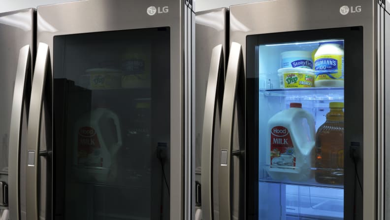 An LG smart fridge with groceries inside.