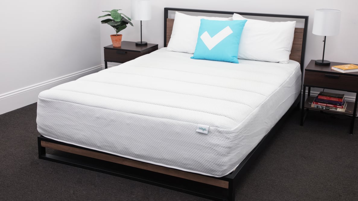 The Vaya Hybrid mattress as part of a bedroom set with a Reviewed pillow on top.