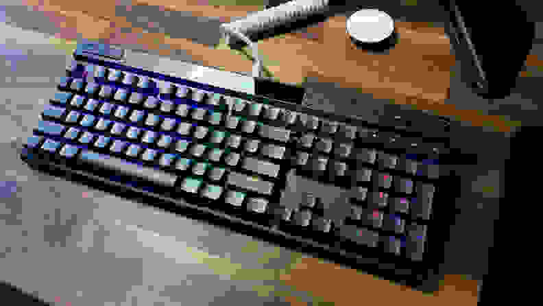 The corsair k70 Max rgb, one of the best gaming keyboards, lit up with RGB lighting and connected with a white cable
