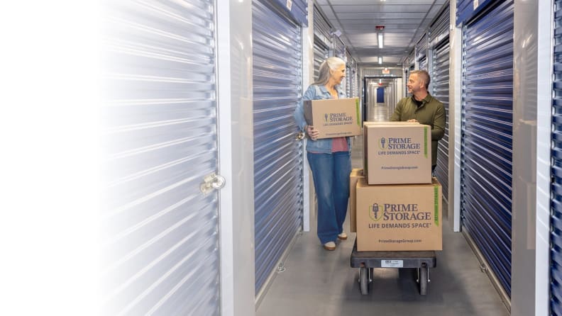 A couple moving their boxes to store inside their self-storage unit