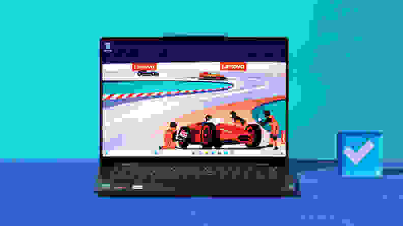 An open and powered on laptop showing a red race car on its screen against a blue backdrop.