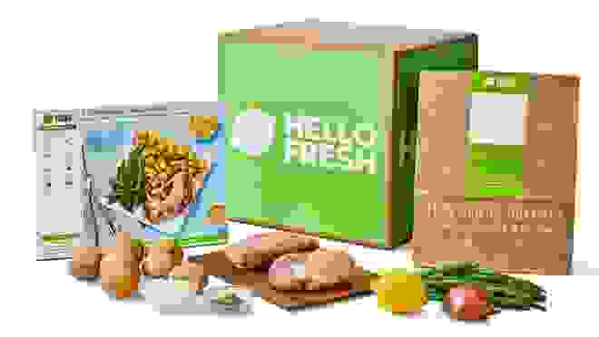 Hello Fresh box with ingredients and menu cards in front