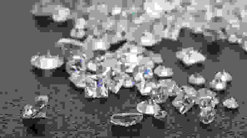 Heap of loose diamonds with brilliant cut and princess cut diamonds, worth considering before buying an engagement ring.