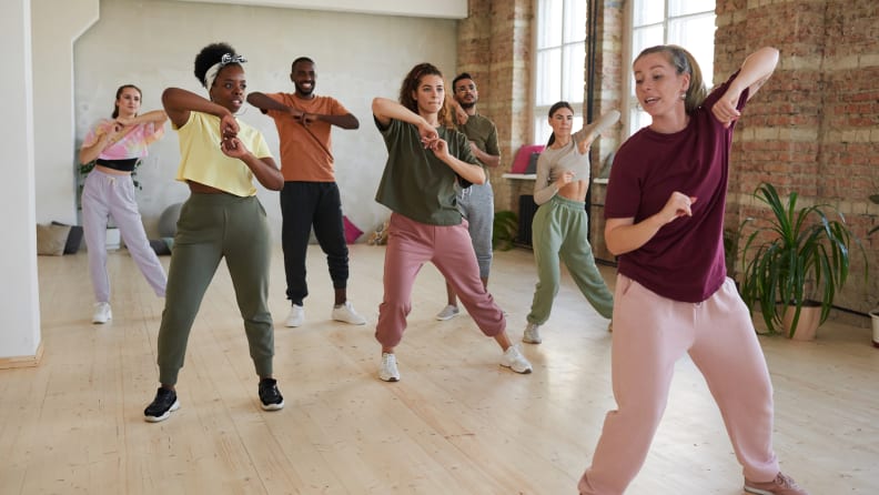 A group of people taking a dance workout class.
