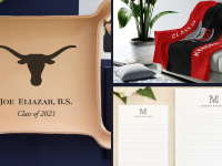 A custom leather tray with college seal next to a blanket on a chair and personalized stationery