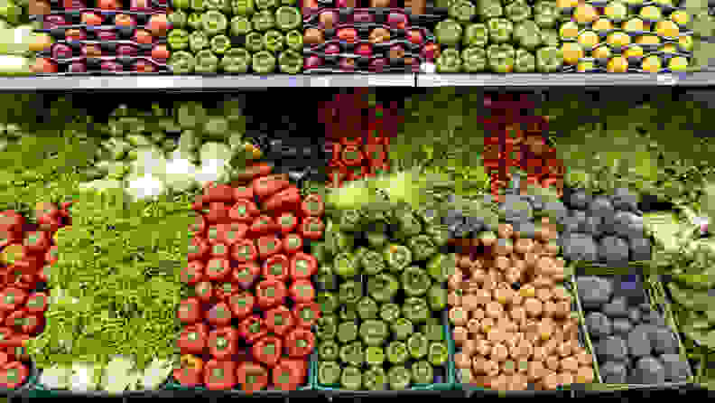 A shot of fully-stocked produce shelves at a grocery store.