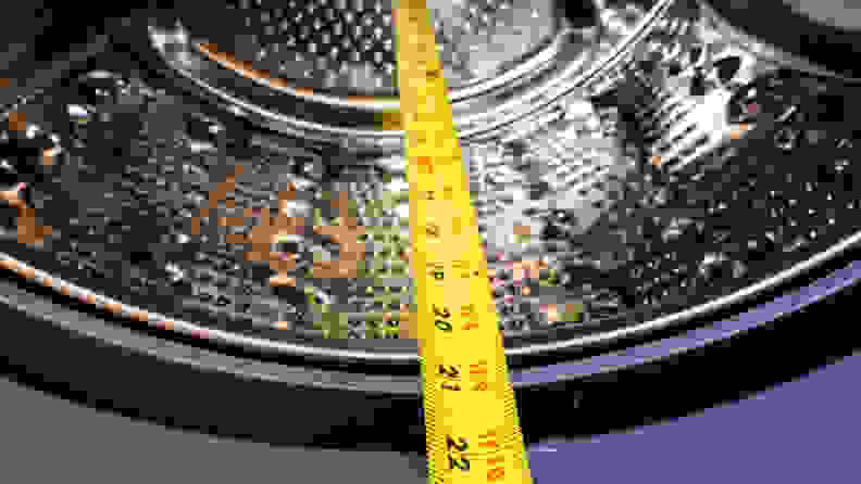 A shot of the LG WM8100HVA front-load washer's drum, with a measuring tape showing the distance from the back of the drum to the front is about 21 inches.