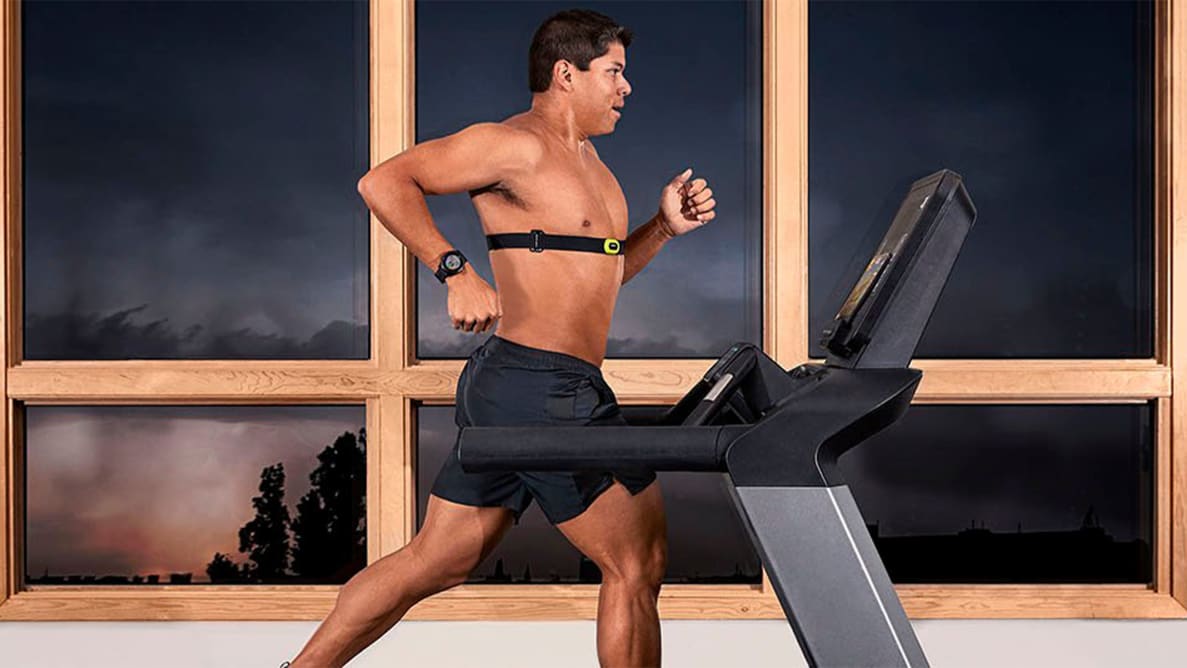 A man running on the treadmill wearing the Garmin HRM-Pro