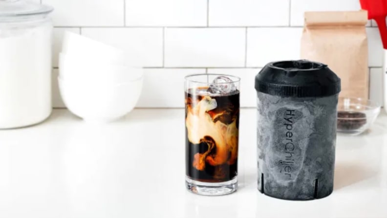 a glass of iced coffee with cream sits next to the hyperchiller