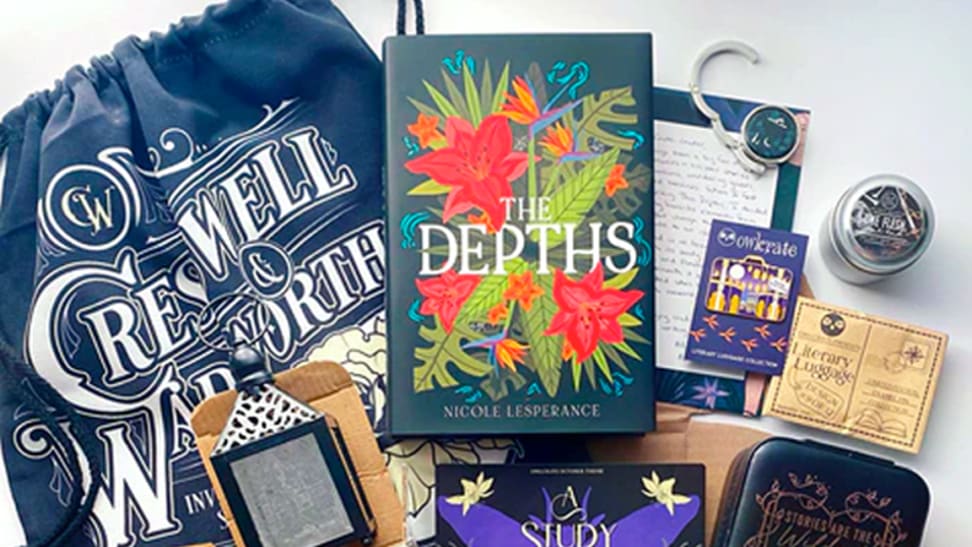 An image of the contents of an OwlCrate box, including a copy of The Depths by Nicole Lesperance, a Cresswell and Wadsworth drawstring bag inspired by Stalking Jack the Ripper, a "One Flesh, One End" candle, a lantern, a jewelry box, a bag holder, and an enamel pin.
