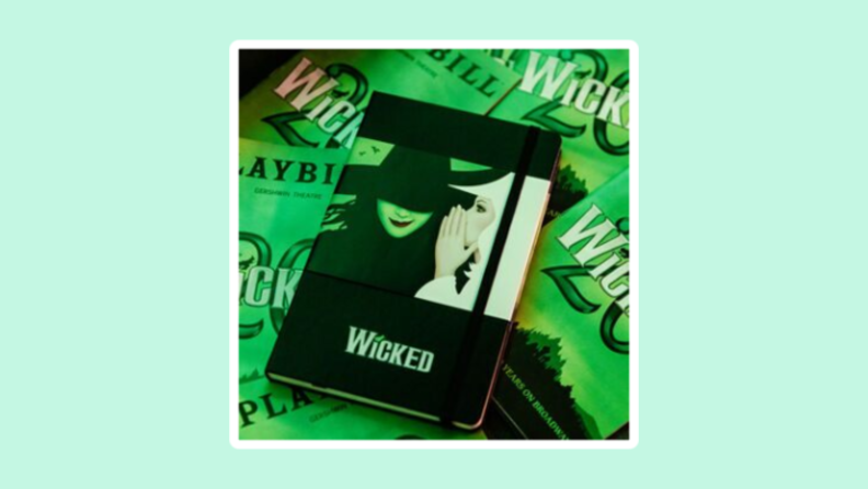 A musical themed Wicked journal with Wicked on the background.