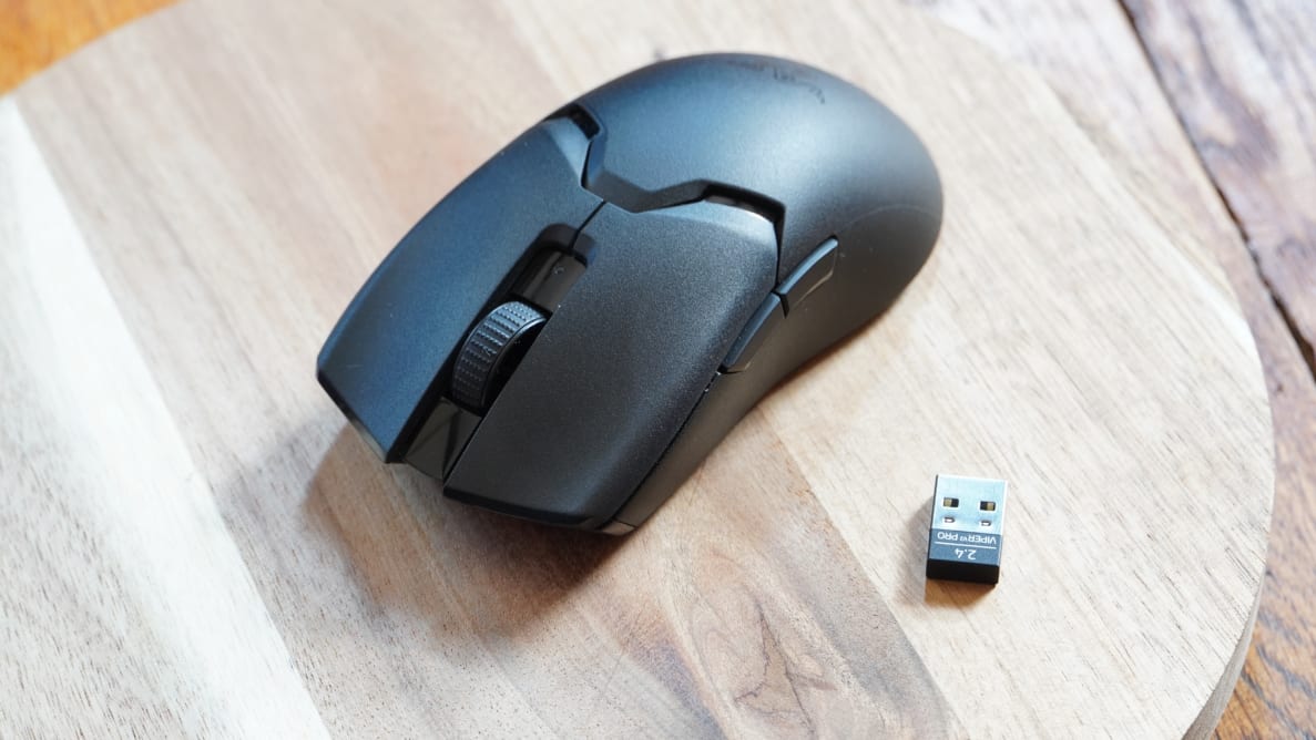 Black Razer Viper V2 Pro computer mouse next to USB piece.
