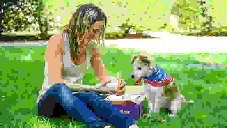 A woman reading the ingredients on dog ice cream inside a PupBox