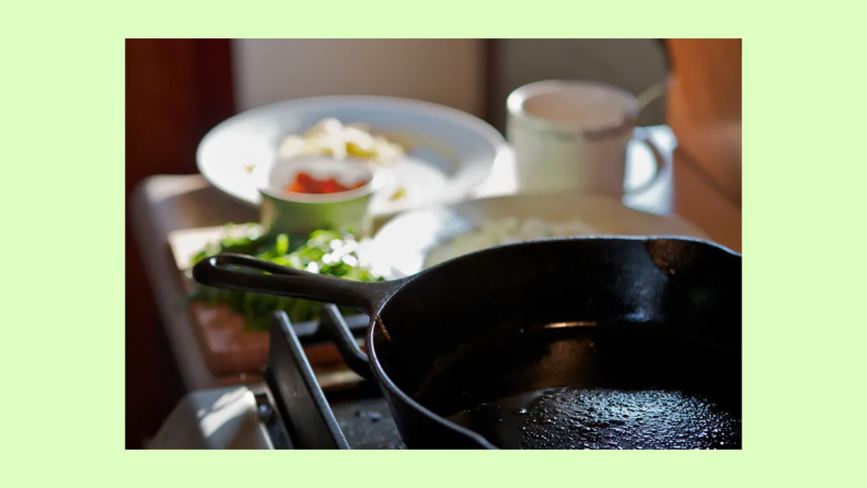 A cast-iron pan sits on a gas cooktop.