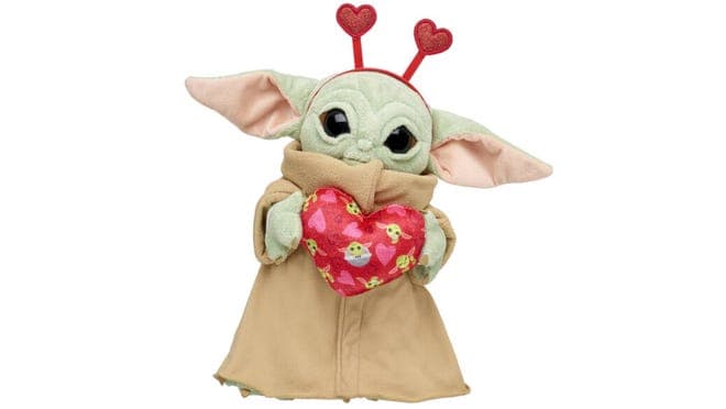 Valentine's Day themed Baby Yoda stuffed animal holding heart.