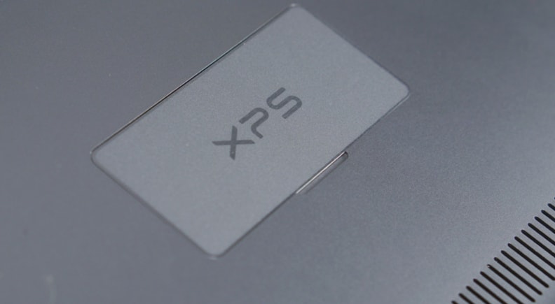 Dell hid the manufacturing symbols behind a thin metal flap, keeping the underside as minimalist as the top.