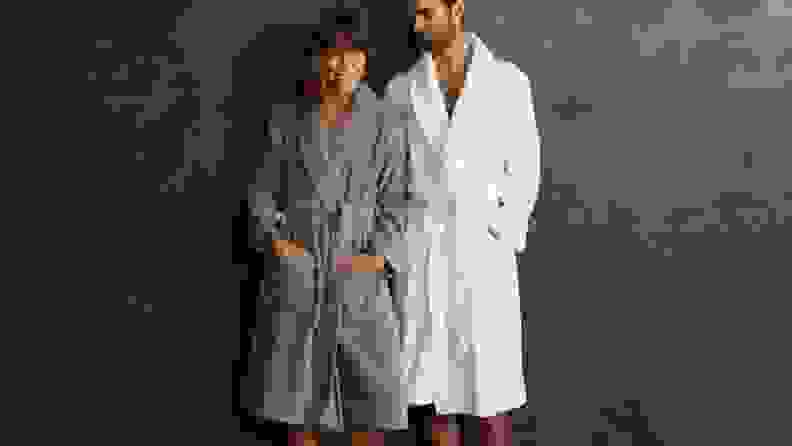 woman and man wearing robes standing side by side