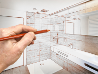 An architect draws plans for a bathroom renovation