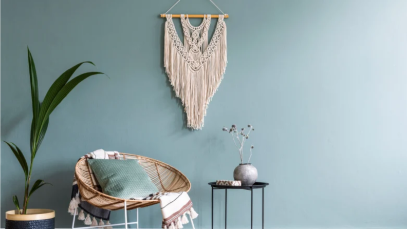 An image of a macrame wall hanging on a blue background