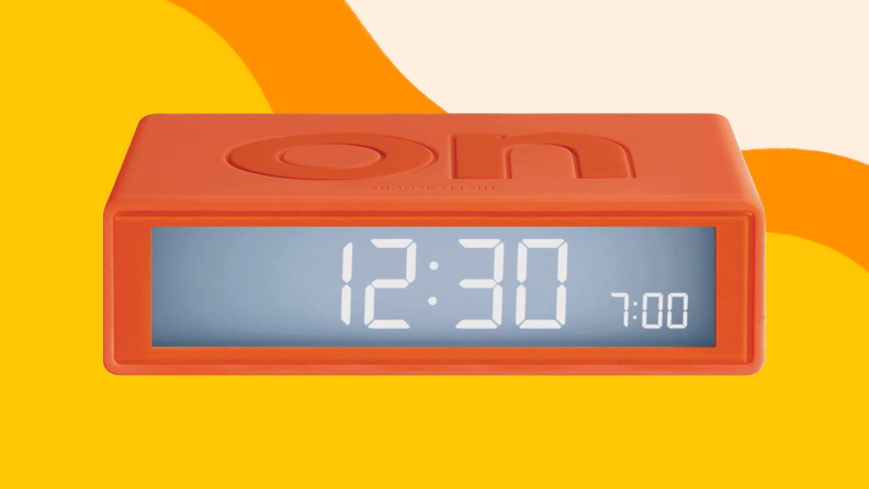 Orange rectangular alarm clock with LED display.