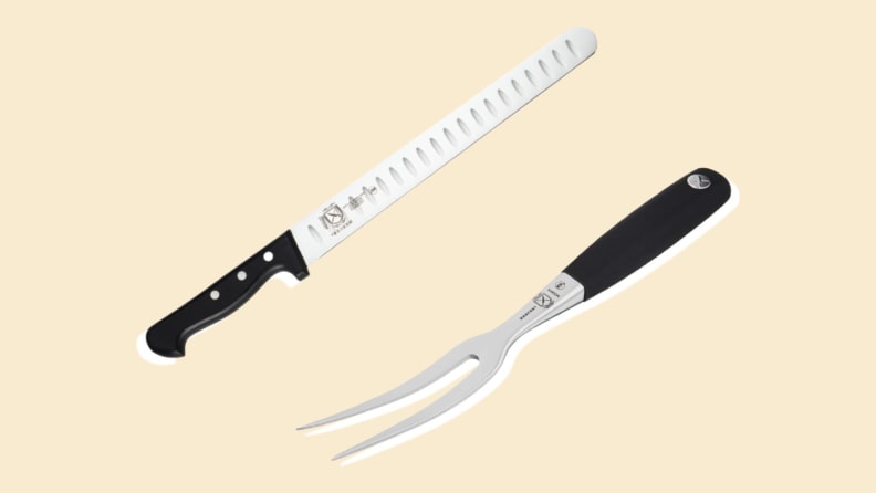 An electric carving knife and fork on a beige background.
