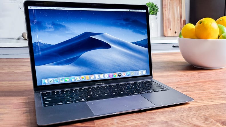 A MacBook Air laptop sits on a table with the screen open.