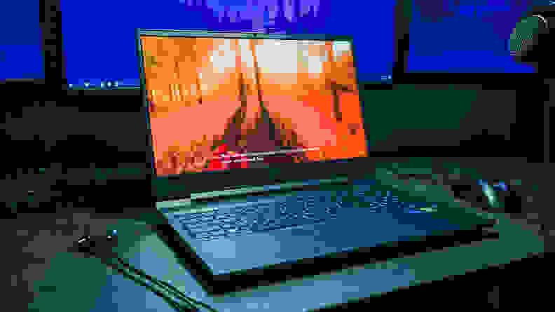Laptop pictured on a desk under a light