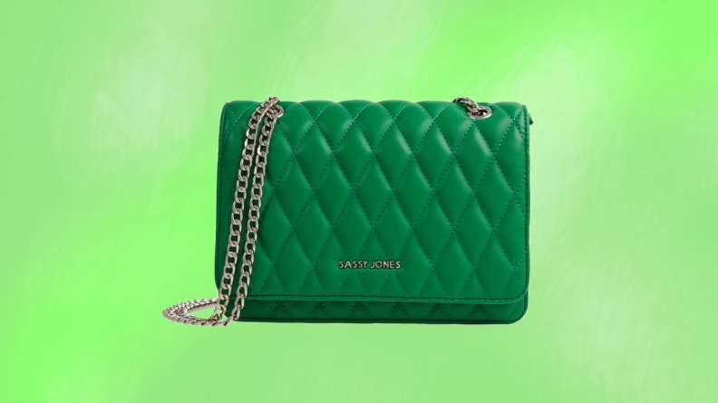 A green crossbody bag in front of a green background.