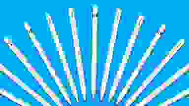 A row of Apple Pencils on a blue background.