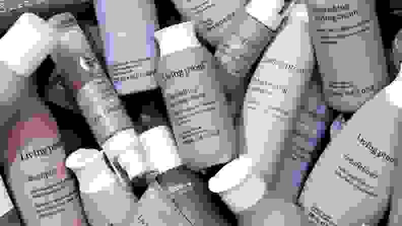 An assortment of multicolored Living Proof creams, shampoos, and sprays.