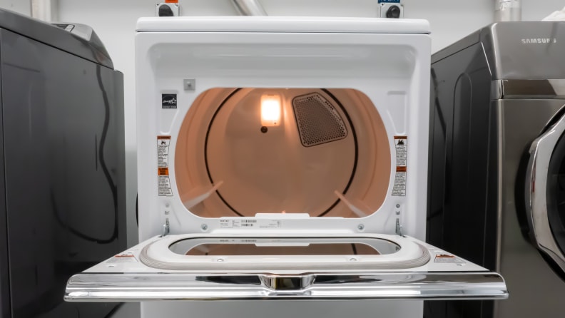 A close-up of the Maytag MED7230HW dryer's drum, illuminated by an internal LED.