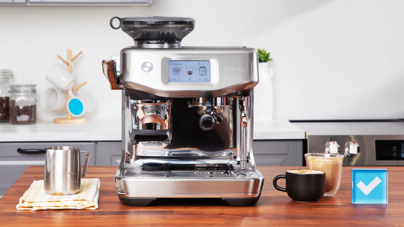 Breville Barista Touch Impress surrounded by espresso beverages on a kitchen counter