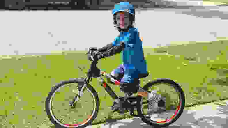 A boy proudly sits on his new bike