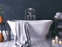 A rustic and dark bathroom with a white standalone tub.