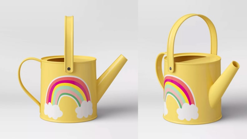 A yellow watering can with a rainbow pattern.