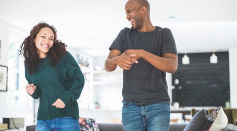 two people dancing in the living room