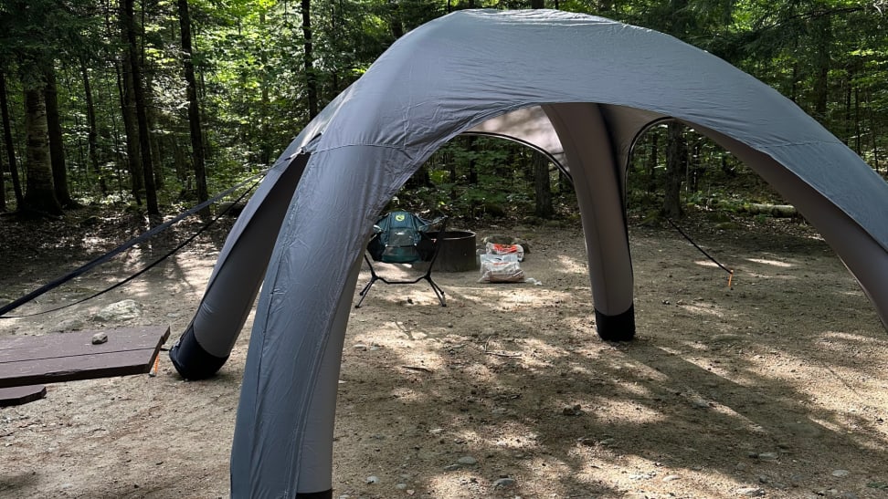 The SOLI tent set up within some woods.