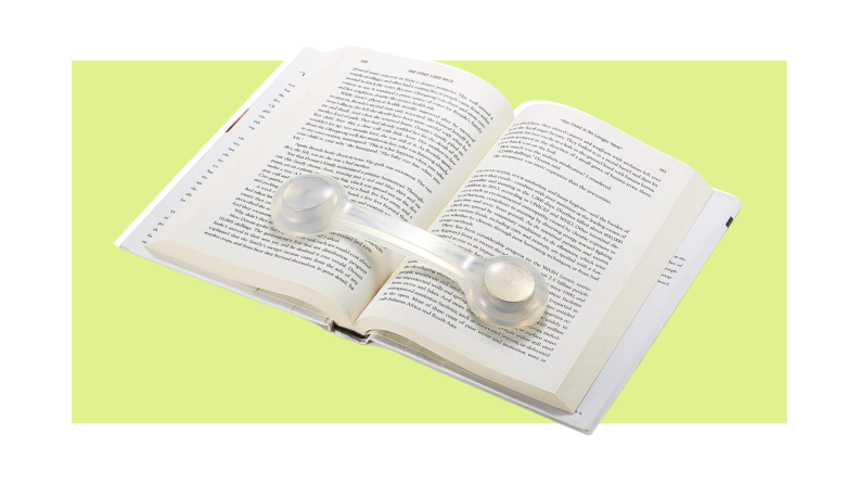 The dog-bone-shaped Superior Essentials book holder sits atop an open book as a weight to hold it open