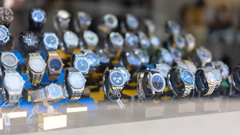 Many watches on display in a store window.