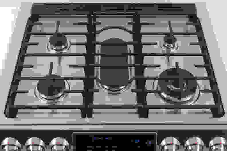 The Samsung NX58H9950WS's rangetop with black burner grates