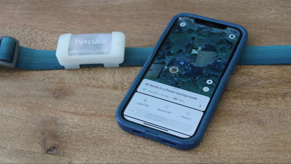 The Petcube GPS Tracker next to an iPhone with the Petcube app.