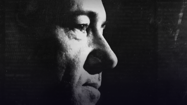 A black-and-white image of Kevin Spacey's face, seen from the side.