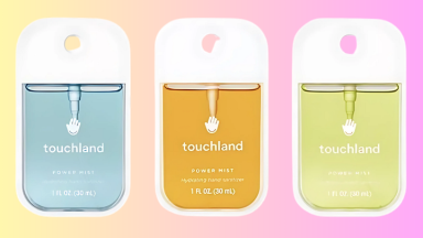 Three Touchland hand sanitizers on a colored background